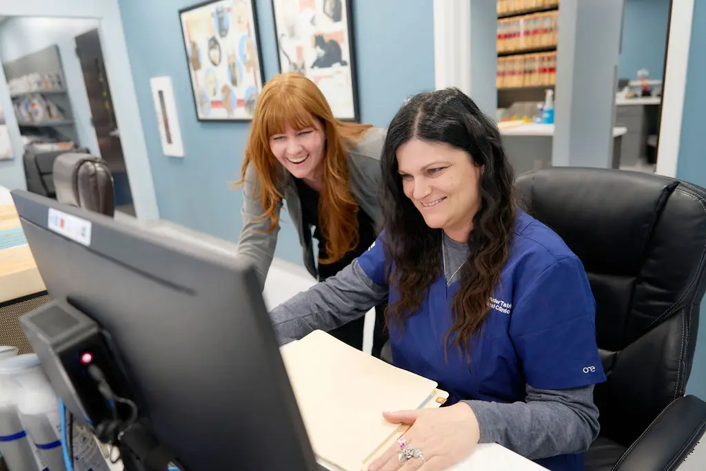 Staff work at the reception desk at Magruder Tabb Animal Clinic.
